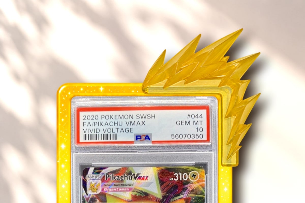 Ionix clipped onto the corner of a graded Pikachu slab in a slab guard