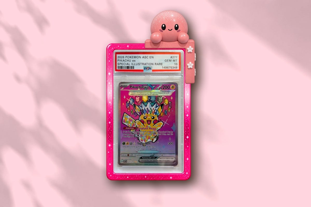 Momo on a graded card slab in a slab guard